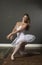 Stunningly beautiful young blonde ballerina in studio