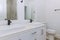 Stunningly remodeled master bathroom after renovation with a marble sink and marble flooring