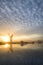 Stunnnig landscape of windmill and river at dawn on Summer morni