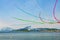 Stunt airplanes performing airshow above a lake with colorful smoke trails. Frecce Tricolore above Lago Maggiore. 25/08/2018 -