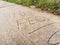 Stupid people carved into side walk