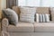 Sturdy brown sofa with grey patterned pillows