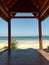 a sturdy wooden pavilion located on the edge of a beautiful beach