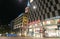 Stuttgart night street with large retail brands noen signage and