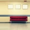 Style minimalism. Red Sofa, interior design, office. Empty waiting room with a modern red sofa in front of the door and three empt