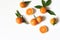 Styled stock photo. Decorative summer fruit composition. Whole and sliced orange tangerines, citrus fruit and leaves