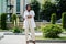 Stylish african american doctor with stethoscope and lab coat posed at backyard of hospital