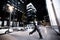 Stylish african american woman walking in night city. Houses illuminated, machines and bicycles on the background