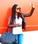 Stylish african woman taking self-portrait picture on smartphone