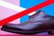 Stylish and arty hipster footwear fashion concept in disco style. Trendy leather men`s shoes with red and white neon light lamps