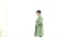 Stylish Asian woman with long green overcoat winter casual fashion on white background Slow motion