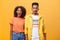 Stylish and attractive brother and sister over orange background yawning with closed eyes and tired expression being