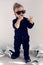 Stylish baby boy in black rocker clothes and sunglasses