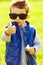 Stylish baby boy with ginger (red) hair in trendy sunglasses
