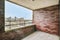 Stylish balcony with brick walls