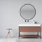 Stylish bathroom interior with a washstand, a round mirror and stool