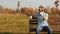 Stylish bearded guy in sunglasses sits on a bench and talking on phone