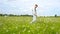 Stylish, bearded man walking in a green field