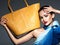 Stylish beautiful  woman wearing blue scarf  with yellow handbag