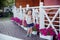 Stylish beautifull cute baby girl with brunette hair posing on wooden garden full of flowers wearing tiny jeans shirts and airy sk