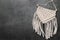 Stylish beige macrame on grey table, top view. Space for text