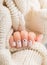 Stylish beige Nails with dots holding knitted wool material