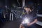 Stylish bicycle mechanic making notes in clipboard in workshop. theme small business selling, repair and service bicycles.