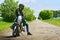 Stylish biker and his beautiful motorbike stoped on a abandoned road.