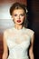 Stylish blond bride girl model in wedding dress