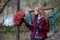 Stylish blonde in red jacket opens umbrella