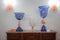 Stylish Blue and Orange Glass Vases Arranged on Wooden Dresser in Elegant Display