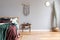 Stylish boho interior of bedroom with design furnitures, honey yellow armchair, macrame,lamp, plant and elegant accessories.