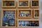 Stylish bookshelf on a white wall. Decorating shelf boxes with cups, little pillows, books and percolator on the wall