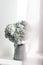 The Stylish bridal bouquet carnations colored in green in a tin pitcher on the window