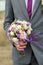 A stylish bridal bouquet of fresh flowers with an accent purple