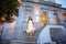 Stylish bride goes on stairs evening background castle Vienne A