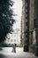 Stylish bride and groom dancing on background of old church in rainy street. Provence wedding. Beautiful emotional wedding couple