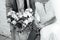 Stylish bride and groom are holding bridal bouquet