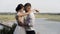 Stylish bride and groom posing on the background of the river and green meadow, love and family concept. Action. Sensual