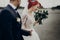 Stylish bride and groom walking and smiling,  with boho bouquet. luxury wedding couple newlyweds, happy emotional moment. space