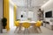 Stylish bright modern dining room interior with yellow elements. Spacious functional dining room interior design with a big table