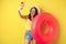 Stylish brunette girl on vacation, taking selfie with swim ring, going on beach, swimming in sea on summer holiday