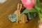 Stylish bunny and tulips on wooden table close up. Happy Easter! Tulips and willow branches bouquet with easter decor in dining