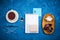 Stylish business flatlay mockup with knolled cup of black tea, notebook, glasses and pencil