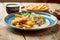 stylish ceramic platter of fish and chips with aioli