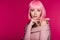 Stylish charming girl posing in pink wig, isolated