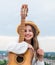 stylish child girl playing guitar outdoor, country music