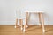 Stylish child table and chair. White and wooden colors. Scandi style