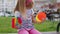 Stylish children girl squeezing presses anti-stress push pop it popular toy on playground bench