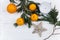 Stylish christmas flat lay with green branches and oranges and g